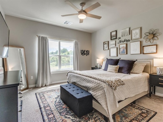 bedroom with light carpet, baseboards, and ceiling fan