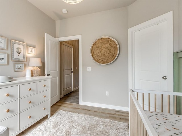 bedroom featuring light wood-style floors and baseboards