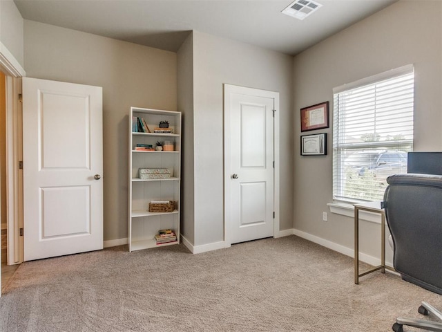 carpeted office featuring baseboards