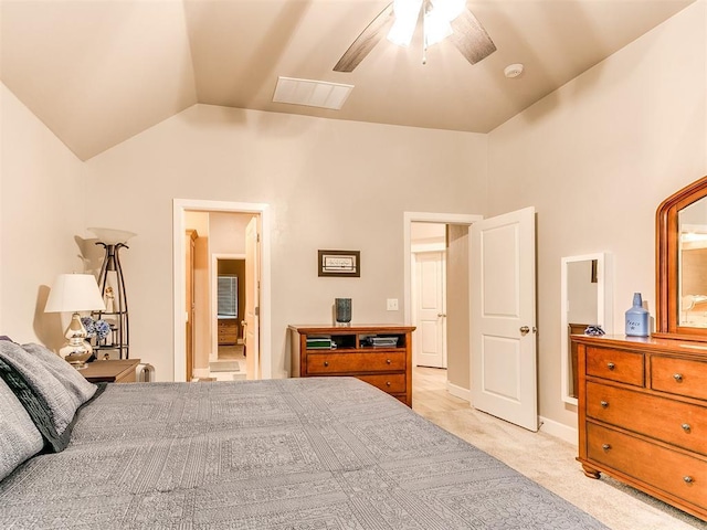 bedroom with vaulted ceiling, light colored carpet, and ceiling fan