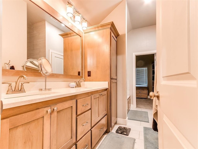 full bath featuring double vanity and tile patterned flooring