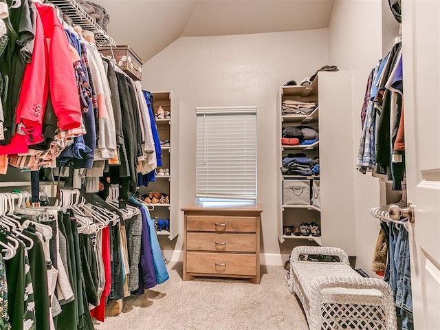 spacious closet featuring carpet and vaulted ceiling