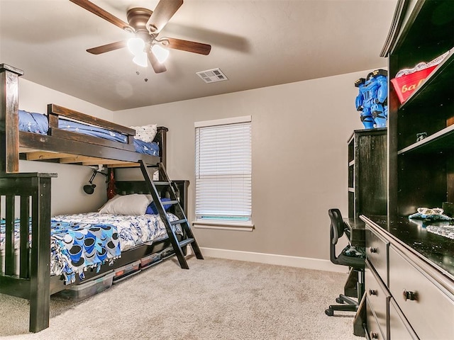 carpeted bedroom with baseboards and a ceiling fan