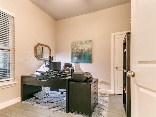 office area with wood finished floors and baseboards