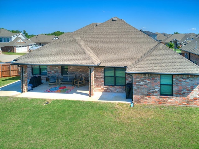 rear view of property featuring a patio, a shingled roof, brick siding, and a residential view