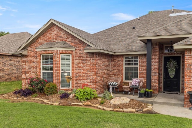 13141 Austrian Pine Dr, Choctaw, OK 73020 - view of front facade featuring roof with shingles, brick siding, a front lawn, and a patio