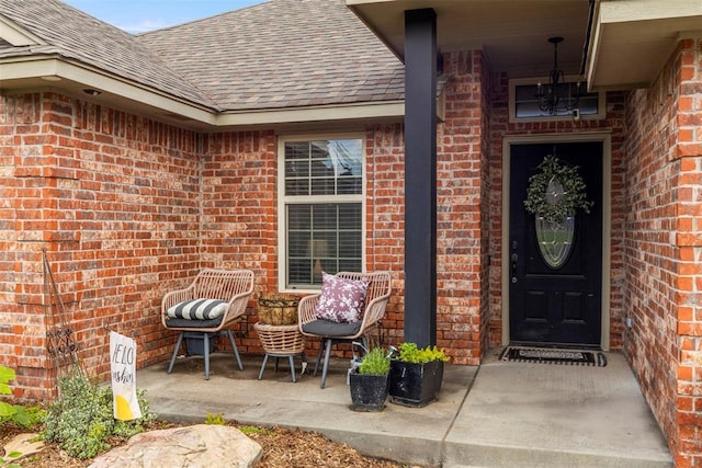 13141 Austrian Pine Dr, Choctaw, OK 73020 - doorway to property featuring a shingled roof and brick siding