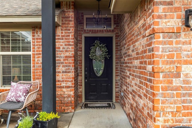 13141 Austrian Pine Dr, Choctaw, OK 73020 - view of exterior entry with brick siding and roof with shingles