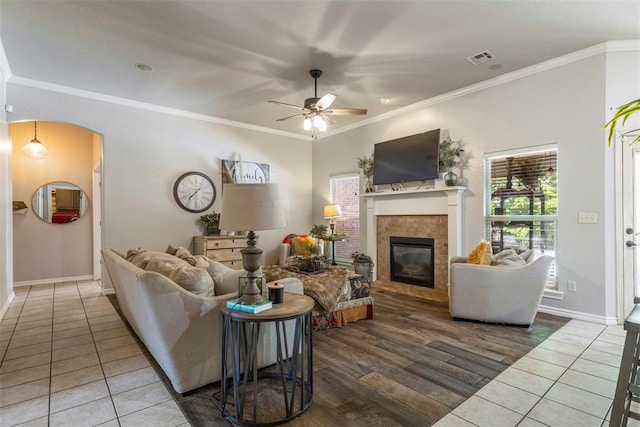 13141 Austrian Pine Dr, Choctaw, OK 73020 - living room with ceiling fan, a fireplace, crown molding, tile patterned floors, and baseboards