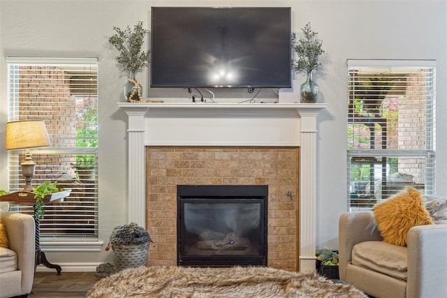 13141 Austrian Pine Dr, Choctaw, OK 73020 - detailed view of a glass covered fireplace, baseboards, and wood finished floors