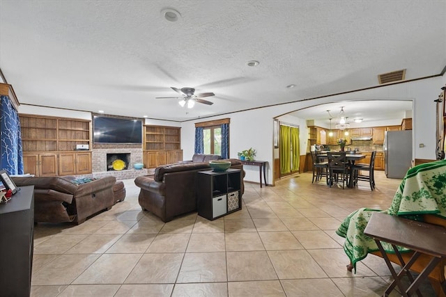 3926 Briarcrest Dr, Norman, OK 73072 - living area featuring arched walkways, light tile patterned floors, a textured ceiling, a ceiling fan, and a fireplace