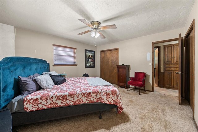 3926 Briarcrest Dr, Norman, OK 73072 - bedroom featuring light carpet, a closet, a ceiling fan, and a textured ceiling