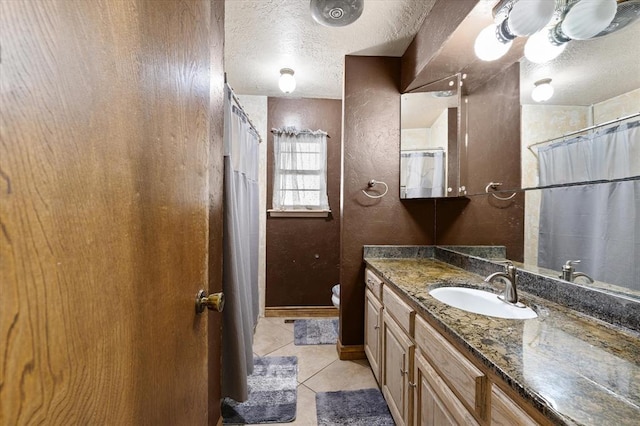 3926 Briarcrest Dr, Norman, OK 73072 - bathroom with tile patterned floors, a textured ceiling, vanity, toilet, and a shower with shower curtain