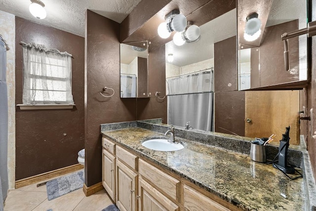 3926 Briarcrest Dr, Norman, OK 73072 - bathroom featuring a textured wall, a textured ceiling, toilet, tile patterned flooring, and vanity