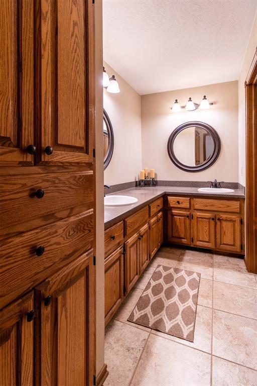 717 Hunters Run, Midwest City, OK 73130 - full bathroom with double vanity and tile patterned flooring