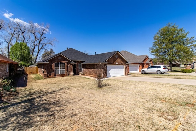 717 Hunters Run, Midwest City, OK 73130 - view of front of home featuring concrete driveway, a garage, brick siding, and roof with shingles