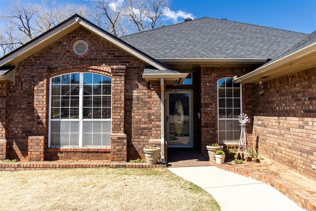 717 Hunters Run, Midwest City, OK 73130 - view of exterior entry with brick siding and roof with shingles