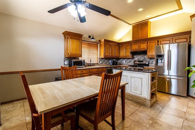 717 Hunters Run, Midwest City, OK 73130 - kitchen featuring appliances with stainless steel finishes, ceiling fan, backsplash, lofted ceiling, and brown cabinets