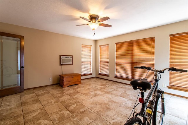 717 Hunters Run, Midwest City, OK 73130 - exercise area featuring ceiling fan, baseboards, and a wall unit AC