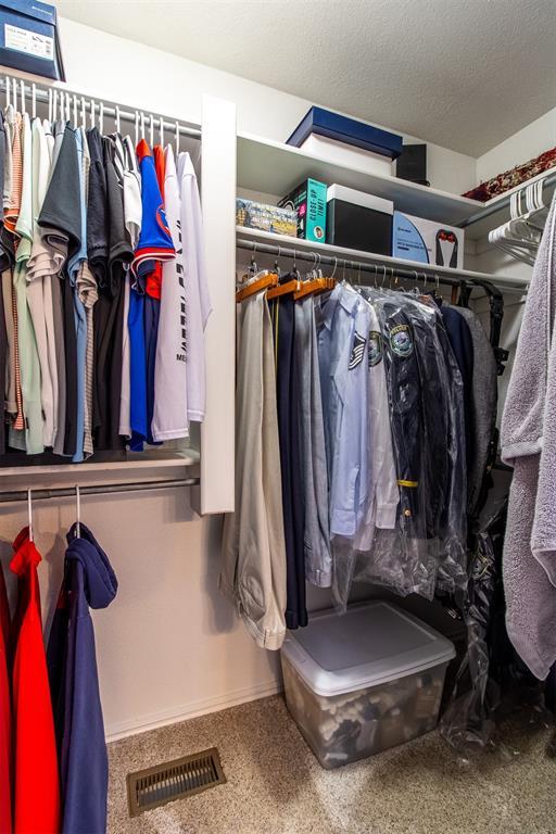 717 Hunters Run, Midwest City, OK 73130 - walk in closet with carpet flooring