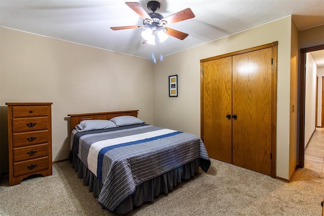 717 Hunters Run, Midwest City, OK 73130 - bedroom featuring light colored carpet, a closet, and a ceiling fan