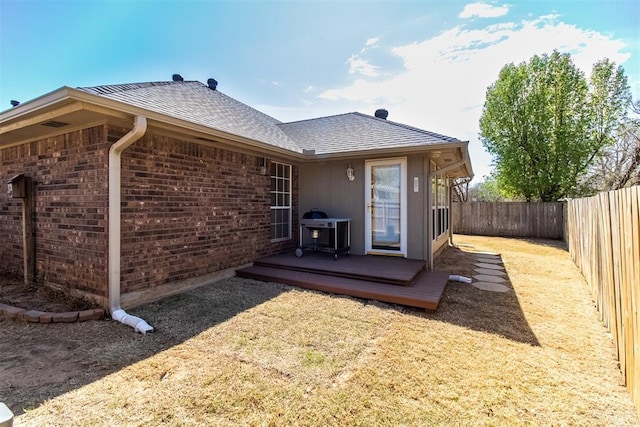 717 Hunters Run, Midwest City, OK 73130 - rear view of house featuring a wooden deck, roof with shingles, and brick siding