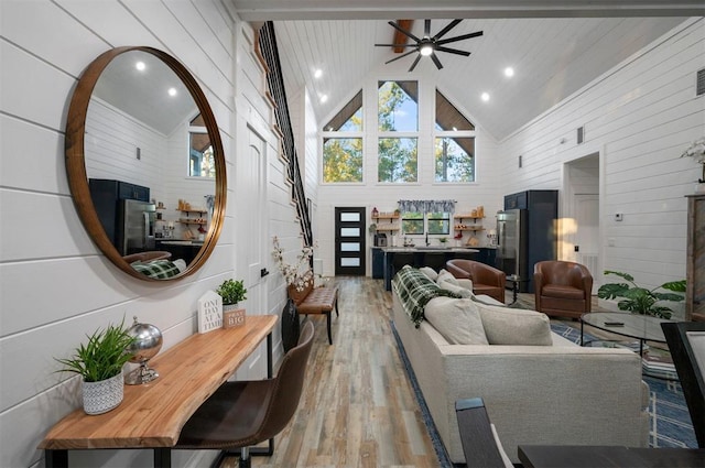 48 Cedar Hills Trl, Broken Bow, OK 74728 - living room with wood walls, light wood-style flooring, a ceiling fan, high vaulted ceiling, and recessed lighting
