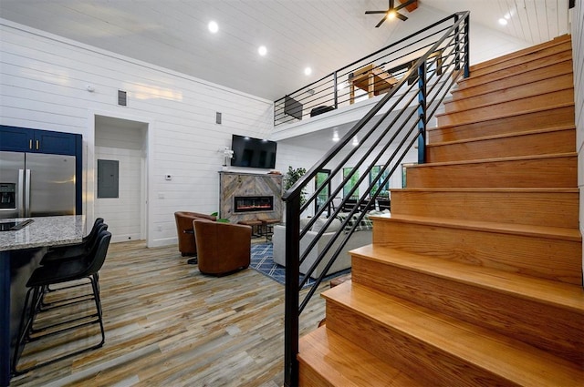 48 Cedar Hills Trl, Broken Bow, OK 74728 - staircase with a premium fireplace, wood finished floors, recessed lighting, electric panel, and wood ceiling