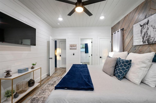 48 Cedar Hills Trl, Broken Bow, OK 74728 - bedroom with wood walls, wood finished floors, wood ceiling, ensuite bath, and recessed lighting