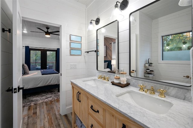 48 Cedar Hills Trl, Broken Bow, OK 74728 - bathroom featuring connected bathroom, wood finished floors, french doors, ceiling fan, and double vanity