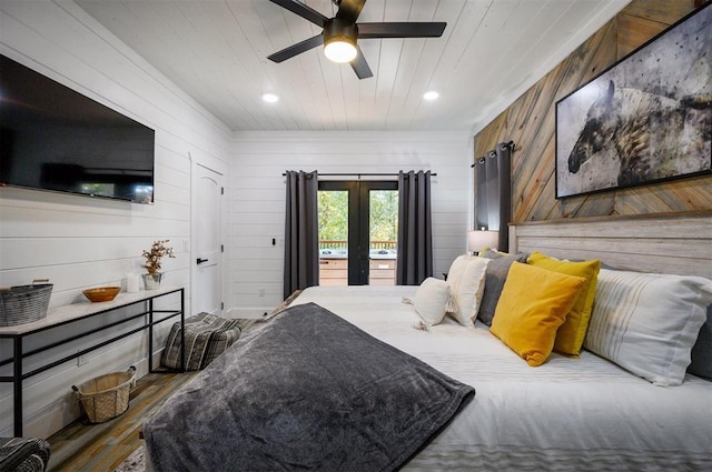 48 Cedar Hills Trl, Broken Bow, OK 74728 - bedroom with french doors, wood finished floors, wooden walls, ceiling fan, and wood ceiling