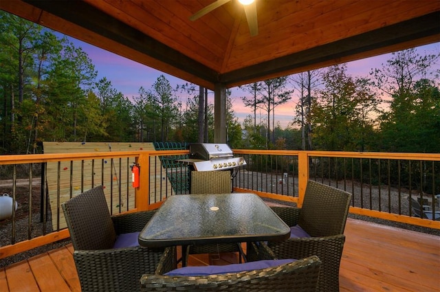 48 Cedar Hills Trl, Broken Bow, OK 74728 - wooden deck featuring a ceiling fan, grilling area, outdoor dining space, and view of scattered trees