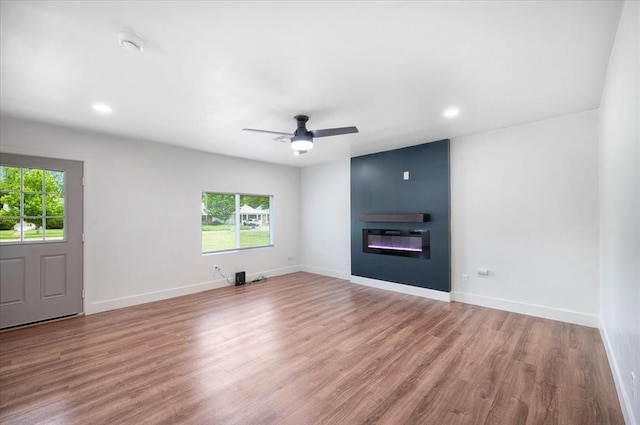 825 W Colorado Ave, Chickasha, OK 73018 - unfurnished living room featuring wood finished floors, a fireplace, recessed lighting, baseboards, and ceiling fan