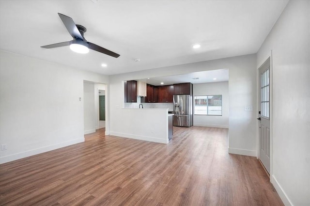 825 W Colorado Ave, Chickasha, OK 73018 - unfurnished living room featuring light wood-style flooring, ceiling fan, baseboards, recessed lighting, and a sink