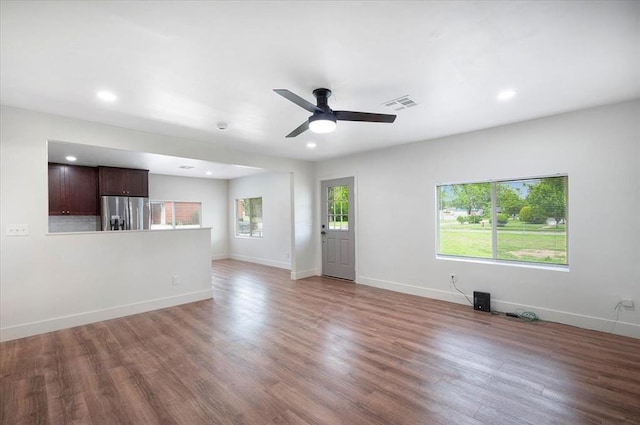 825 W Colorado Ave, Chickasha, OK 73018 - unfurnished living room featuring wood finished floors, ceiling fan, baseboards, and recessed lighting
