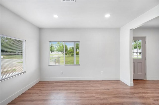 825 W Colorado Ave, Chickasha, OK 73018 - empty room with light wood-type flooring, recessed lighting, and baseboards