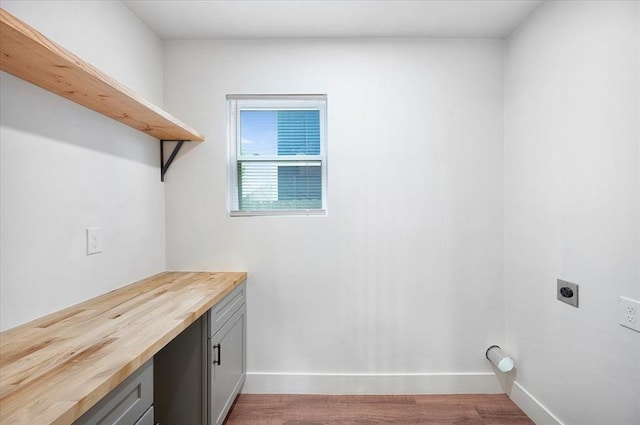 825 W Colorado Ave, Chickasha, OK 73018 - laundry area featuring hookup for an electric dryer, wood finished floors, and baseboards