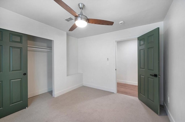825 W Colorado Ave, Chickasha, OK 73018 - unfurnished bedroom with light colored carpet, a closet, baseboards, and ceiling fan