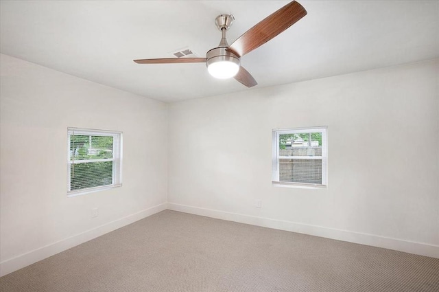 825 W Colorado Ave, Chickasha, OK 73018 - unfurnished room with healthy amount of natural light, light carpet, baseboards, and ceiling fan