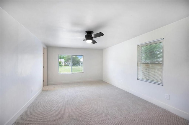 825 W Colorado Ave, Chickasha, OK 73018 - spare room featuring ceiling fan, carpet, and baseboards