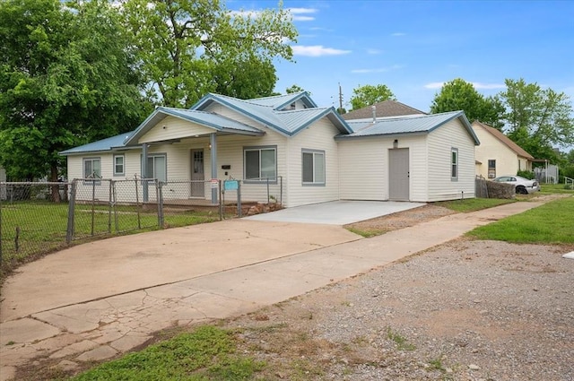 825 W Colorado Ave, Chickasha, OK 73018 - view of front facade featuring metal roof, concrete driveway, and a porch