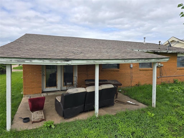 3401 SW Abilene Dr, Lawton, OK 73501 - rear view of house featuring brick siding, roof with shingles, a yard, outdoor lounge area, and a patio