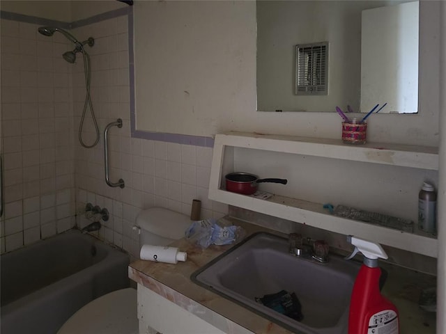 3401 SW Abilene Dr, Lawton, OK 73501 - bathroom featuring tile walls, toilet, shower / washtub combination, and vanity
