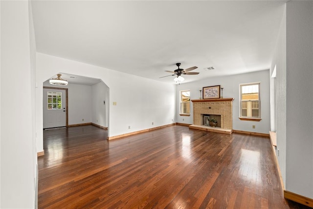 unfurnished living room with wood finished floors, a ceiling fan, and baseboards