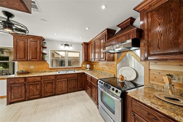 kitchen featuring stainless steel range with electric cooktop, a sink, light stone countertops, open shelves, and recessed lighting