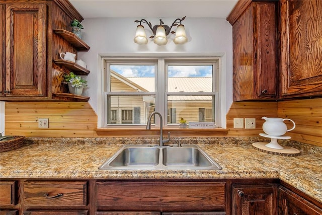 kitchen featuring a sink, open shelves, and brown cabinets
