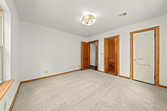 unfurnished bedroom featuring carpet flooring and baseboards