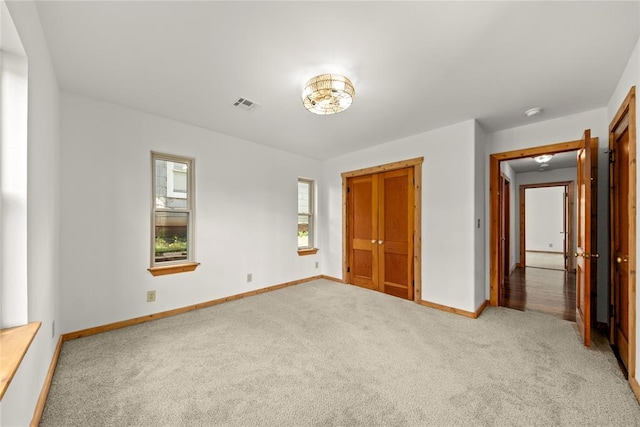 unfurnished bedroom featuring carpet, baseboards, and a closet