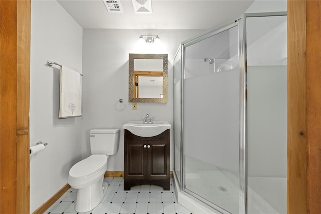 full bathroom featuring toilet, a shower stall, vanity, baseboards, and tile patterned floors