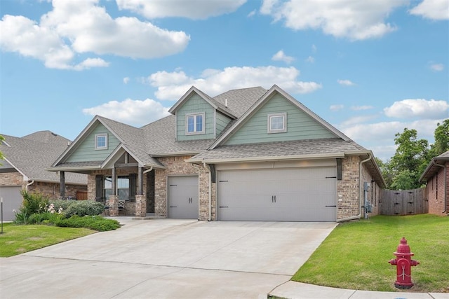 8400 Poplar Dr, Edmond, OK 73034 - view of front of house featuring roof with shingles, concrete driveway, covered porch, and a gate